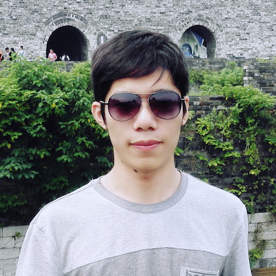 I am Fukang. I am wearing a white T-shirt with green bushes behind me.